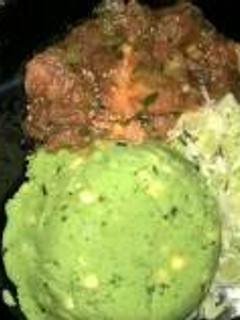 A picture of Mukimo served with wet fry beef and steamed cabbage.