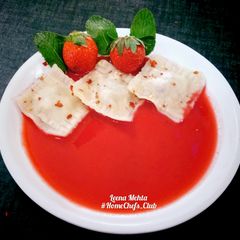 A picture of Dry Fruits Ravioli with Strawberry sauce.