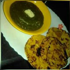 A picture of Sarso ka saag with makke ki roti.