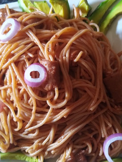 A picture of Spaghetti with smoked chicken sausage and avocado.