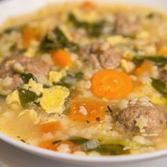 A picture of Italian wedding soup with meatballs.