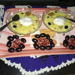 A picture of Fruit custard with icecream.