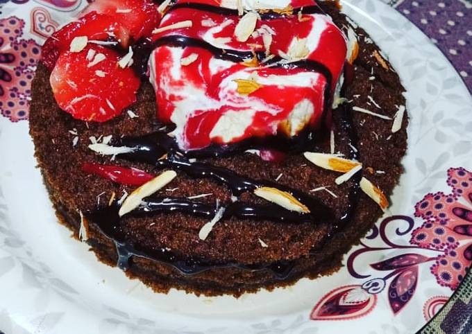 Chocolate cake with vanilla ice cream and strawberry sauce