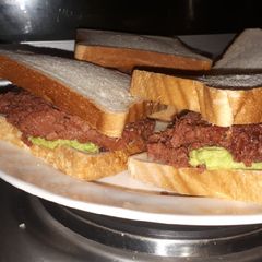A picture of Avocado and corned beef sandwich.