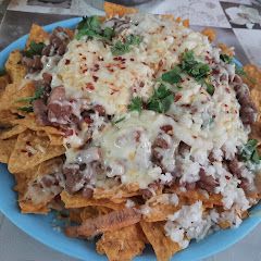 A picture of Nachos with salsa.