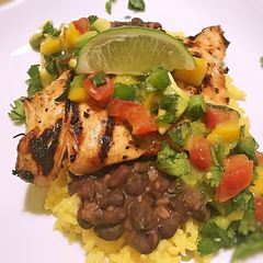 A picture of Island chicken with beer braised black beans and yellow rice.