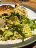Savoy cabbage and green leaves salad with tasty dressing