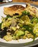 Savoy cabbage and green leaves salad with tasty dressing