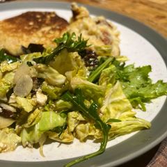 A picture of Savoy cabbage and green leaves salad with tasty dressing.