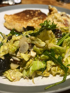 A picture of Savoy cabbage and green leaves salad with tasty dressing.