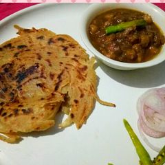A picture of Amritsari chole with lacha paratha.