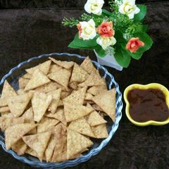 A picture of Spicy crispy mexican nachos in desi style with mix lentils.
