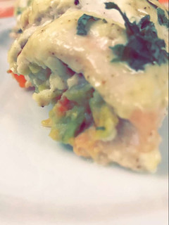 A picture of Chicken filled with avocado.