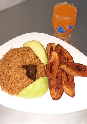 A picture of Jollof Rice and Fried beef.