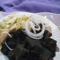 A picture of Periwinkle (Piom Piom) and Kpomo Garnished with Garden Eggs.