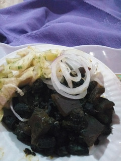 A picture of Periwinkle (Piom Piom) and Kpomo Garnished with Garden Eggs.