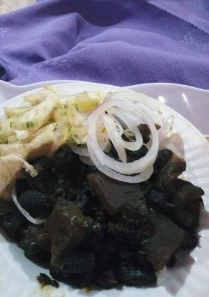 A picture of Periwinkle (Piom Piom) and Kpomo Garnished with Garden Eggs.