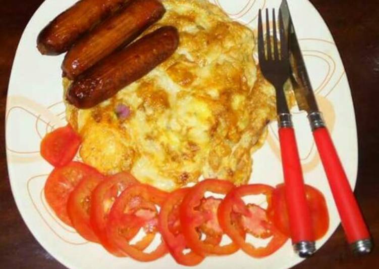 Fried eggs and sausages.. garnished with tomatoes