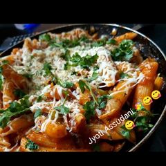 A picture of Pink pasta with sauce.