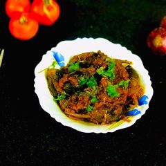 A picture of Brinjal curry in tomato gravy.
