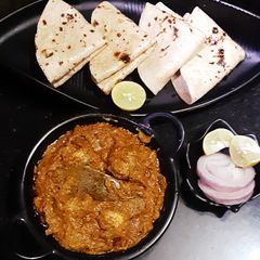 A picture of Mushroom tikka masala, tawa roti, salad.