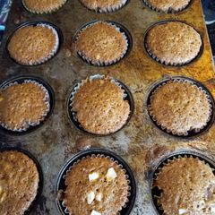 A picture of Carrot cupcakes with sliced almonds.