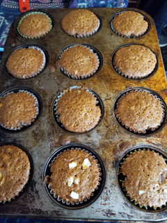 A picture of Carrot cupcakes with sliced almonds.