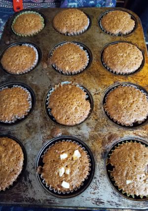 A picture of Carrot cupcakes with sliced almonds.