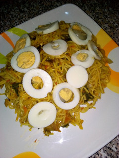 A picture of Spaghetti joloff with boiled egg.