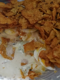 A picture of Cucumber, egg and chip salad.