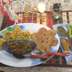 A picture of Combo of dhokla aloo paratha chole and tikki.