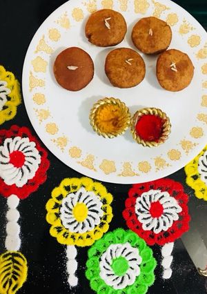 A picture of Ghila Pitha / Tel Pitha : RICE FLOUR AND JAGGERY FRITTERS.