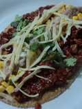 Huarache de chicharrón prensado, elotes y queso ala mexicana. México