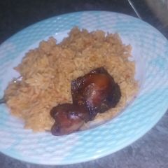 A picture of Jollof rice and fry chicken.