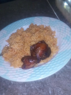 A picture of Jollof rice and fry chicken.