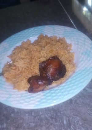A picture of Jollof rice and fry chicken.