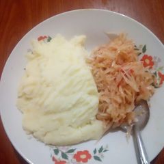 A picture of Smashed potatoes with steamed cabbage.