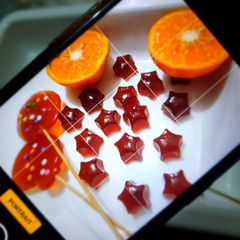 A picture of Orange 🍊 candies 🍬🍬and lolipops 🍭🍭.