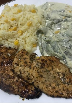 A picture of Rajas with Cream and Corn, Served with Chicken Breast and Rice.