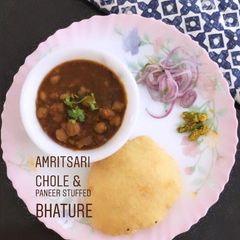 A picture of Amritsari chole and paneer stuffed bhature.