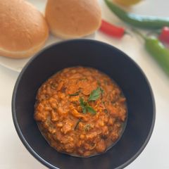 A picture of Spicy Fava Beans with burger bun.