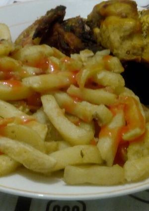 A picture of French fries with chicken.