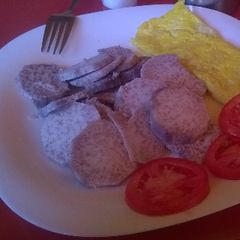 A picture of Arrowroots served with fried egg and tomatoes.