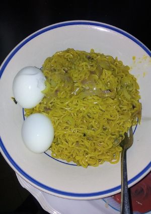 A picture of Turmeric Indomie with boiled egg.