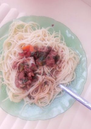 A picture of Spaghetti and beef stew.