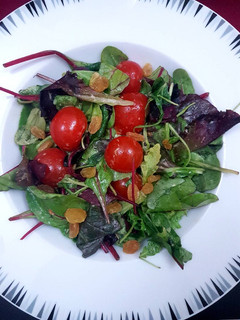 A picture of Spring mix salad with digon mustard dressing.