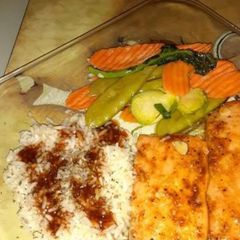 A picture of Steamed salmon,rice, vegetables w/ cherryaki sauce.