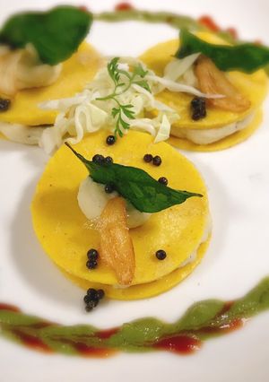 A picture of Crepe khandvi ravioli with mashed potatoes.
