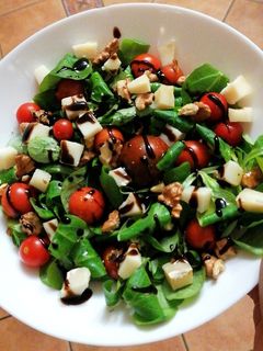 Una foto de Ensalada de canónigos, tomates cherry y queso de cabra
