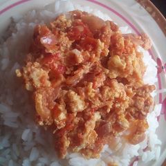 A picture of Eeg sauce and white rice.